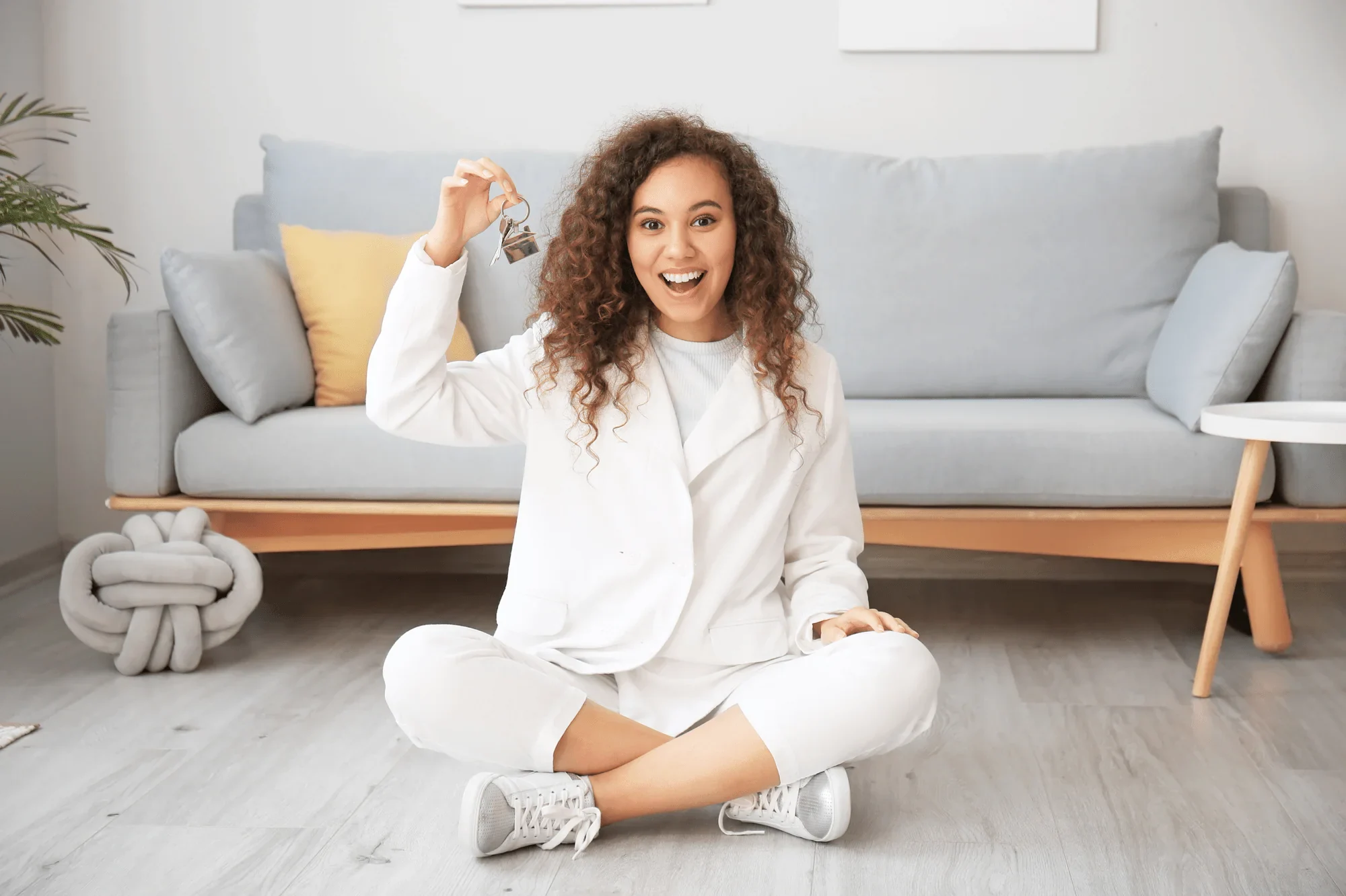 A happy woman holding house keys
